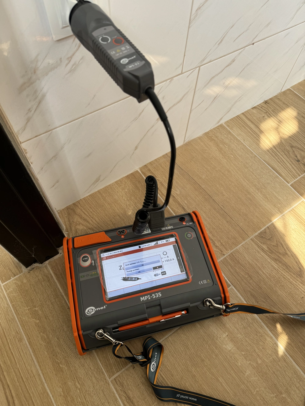 Przenośny tester podłączony do gniazda do pomiarów instalacji elektrycznych
